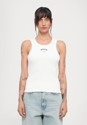 White ribbed tank top with a round neckline and a small black logo text at the center, paired with light blue baggy jeans.