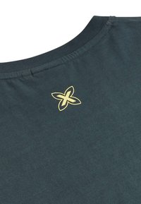 Green cotton t-shirt featuring a round neckline and a gold floral logo on the back. Soft texture with a slight stretch and casual fit.
