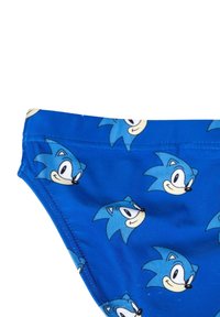 Maillot de bain bleu avec un motif graphique répétitif représentant un personnage de hérisson en dessin animé avec un visage souriant et des piquants stylisés. Texture lisse.