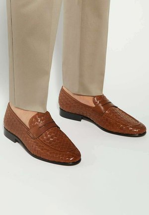 Brown woven leather loafers with a smooth finish, featuring a decorative band across the vamp and a low-profile black sole.