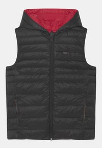 Black puffer vest with a zip front, hood, and red lining. Features quilted texture and two side pockets with minimal hardware.
