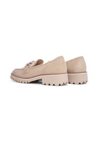 Beige suede shoes with a rounded toe, lace-up design, and a chunky, ridged sole. The sole features a contrasting white accent.