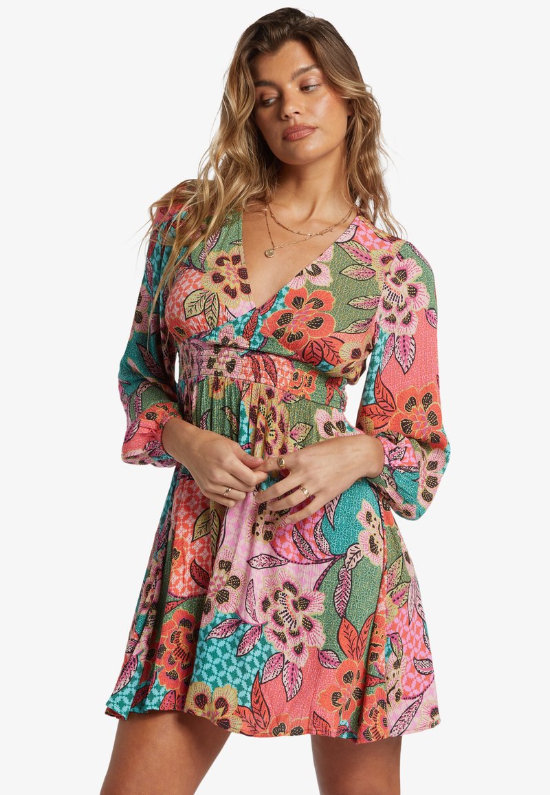 Blumenmusterkleid mit lebhaften Farben wie Pink, Grün und Türkis. V-Ausschnitt, lange Ärmel und eine geraffte Taille mit einem fließenden Rock.