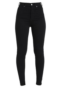 Jeans skinny de cintura alta en negro con cierre frontal de botón y cremallera, pasadores para cinturón y bolsillos delanteros y traseros.