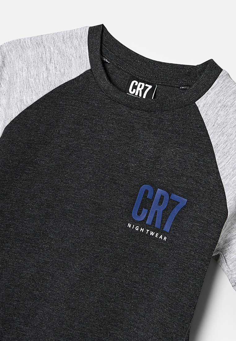 T-shirt à manches raglan gris foncé et gris clair avec "CR7 NIGHTWEAR" imprimé sur la poitrine et une étiquette CR7 à l'intérieur du col.