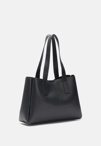 Black leather tote bag with two long handles, boxy design, smooth texture, and open top, featuring subtle stitching details on the edges.