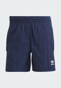 Navy blue athletic shorts with an elastic waistband, side pockets, and white Adidas logo. Features textured fabric and minimalistic design.