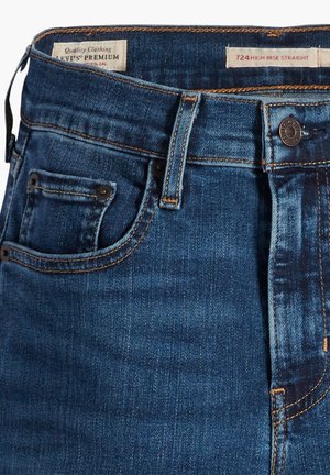 Jeans in denim a gamba dritta alta in blu scuro con cuciture dorate, chiusura con bottone in metallo e una piccola tasca per le monete frontale.