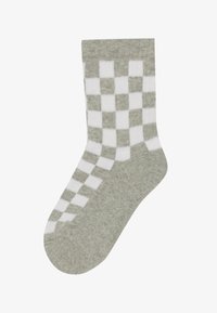 Calzini grigi con un motivo a scacchi bianchi. Lunghezza media con una finitura morbida e texture. Punta arrotondata e polsino a coste.