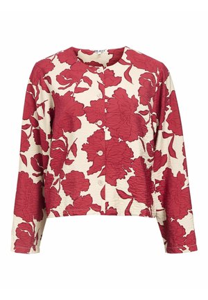 Blouse boutonnée à motifs floraux rouges sur fond crème, avec un col rond, des manches longues et un tissu texturé.