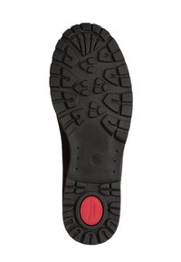 Semelle d'une chaussure noire avec des rainures profondes et un insert circulaire rouge près du talon étiqueté "Tamaris Comfort" avec la taille 37 visible.