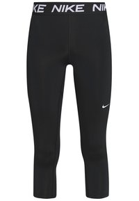 Leggings capri noirs en tissu extensible, avec un logo Nike blanc sur la jambe gauche et une taille élastique marquée.
