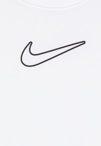 Λευκό μπλουζάκι από βαμβάκι με το λογότυπο Nike swoosh σε μαύρο χρώμα στο μπροστινό μέρος. Διαθέτει στρογγυλή λαιμόκοψη και κοντά μανίκια.