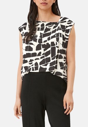 Black and white abstract patterned blouse, short sleeves, draped neckline, lightweight fabric, paired with black trousers.