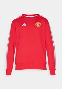 Felpa rossa a maniche lunghe del Manchester United con logo Adidas bianco e tre strisce bianche che scorrono lungo ciascun manica.