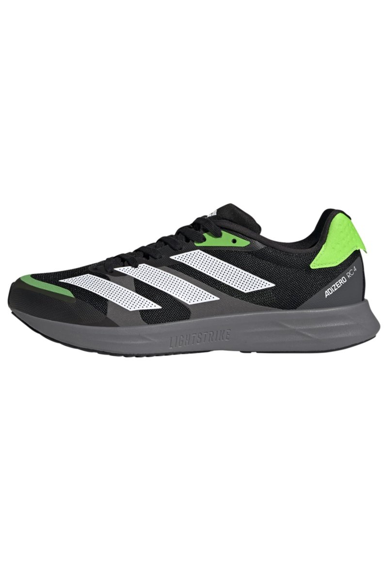 Scarpa atletica nera con strisce bianche e accenti verdi, caratterizzata da una tomaia in rete, intersuola Lightstrike e suola in gomma testurizzata.