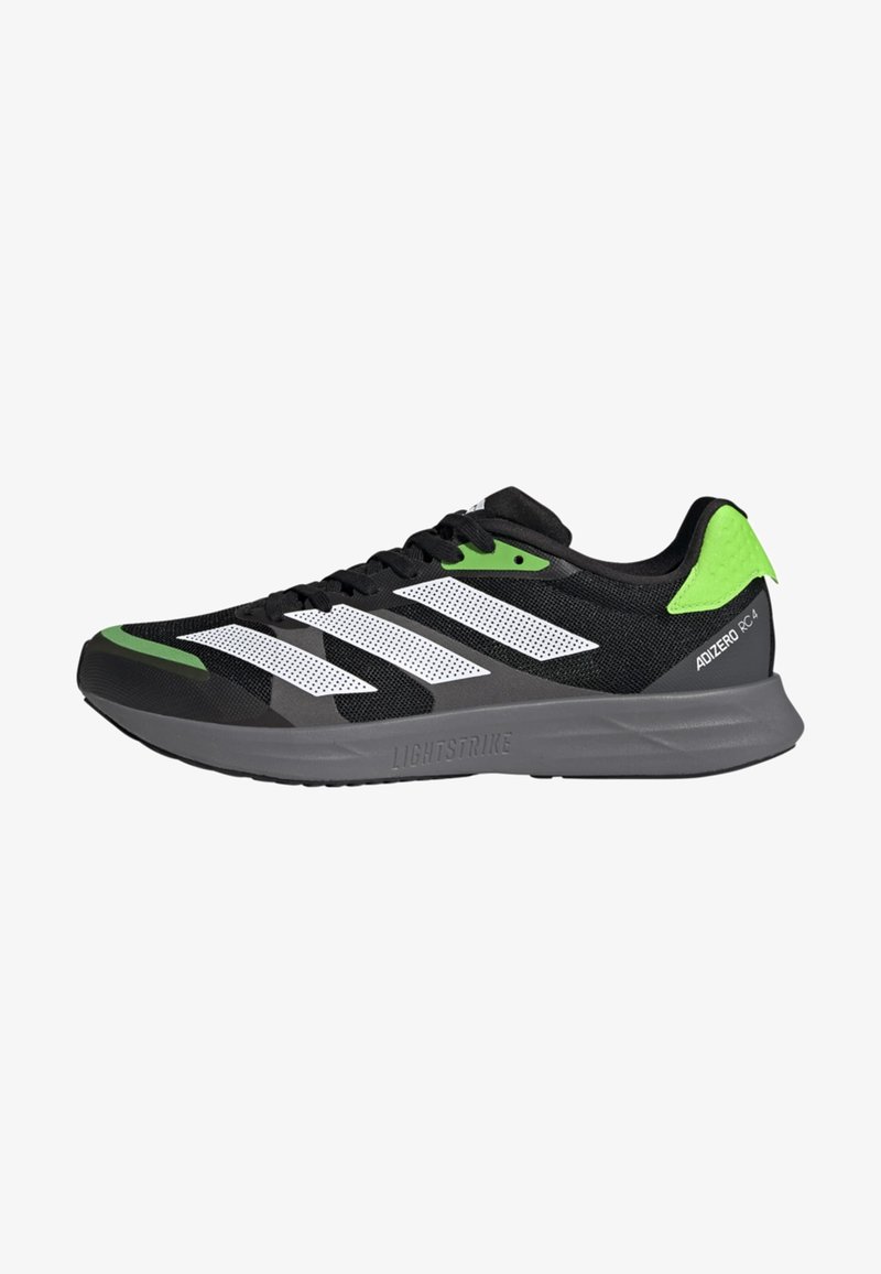 Scarpa atletica nera con strisce bianche e accenti verdi, caratterizzata da una tomaia in rete, intersuola Lightstrike e suola in gomma testurizzata.