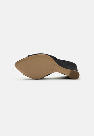 Black fabric slip-on shoe with a pointed toe and low, tapered heel. Beige rubber sole with subtle embossed text. Smooth, textured finish.
