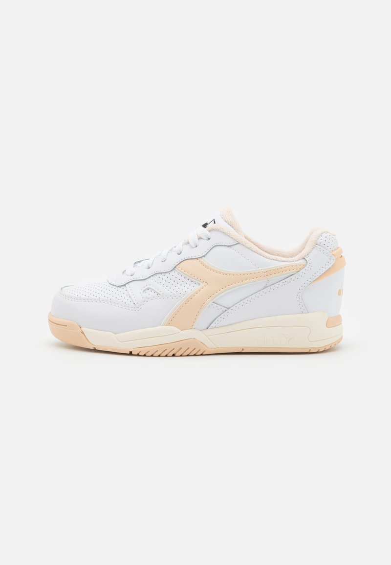 White leather sneakers with a peach accent, perforated texture, flat laces, and a rubber sole. Features a side logo and padded collar.
