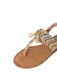 Sandalo piatto in tessuto intrecciato con suola in eco-pelle marrone, caratterizzato da hardware dorato e frange decorative in crema e marrone.