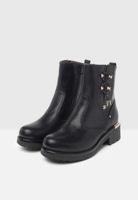 Black leather ankle boots with a round toe, side zip closure, and decorative hardware details. Sturdy rubber sole with a slight heel.