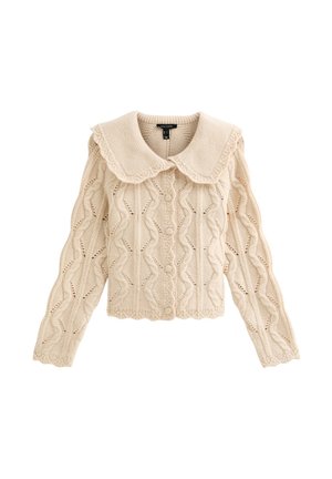 Cárdigan beige de punto con cuello festoneado, patrón texturizado y cierre con botones. Mangas largas con bordes acanalados y detalles de tejido abierto.