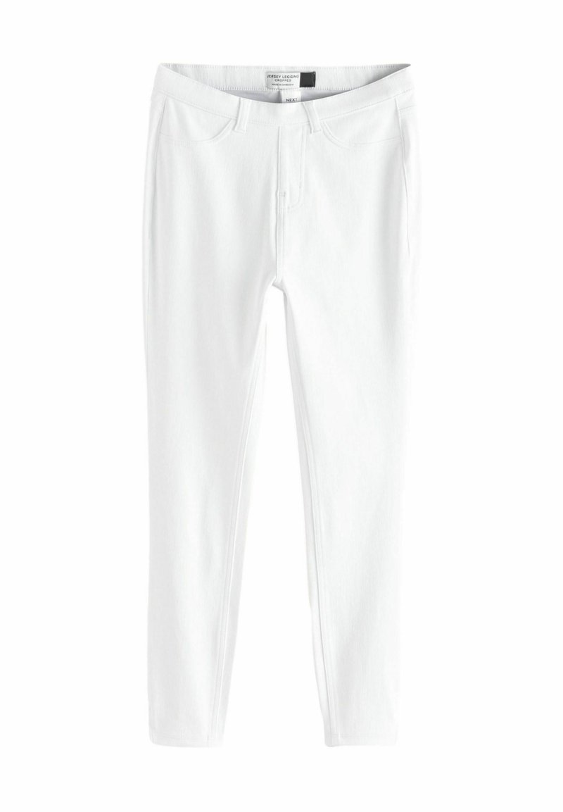 Witte jersey legging met een getailleerd ontwerp, voorzien van een standaard tailleband, twee voorzakken en een gladde, licht gestructureerde oppervlakte.