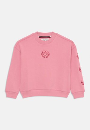 Sweatshirt rose en tissu doux, arborant un logo en forme de cœur avec "TOMMY HILFIGER" et des accents floraux sur le devant et les manches. Ourlet et poignets côtelés.