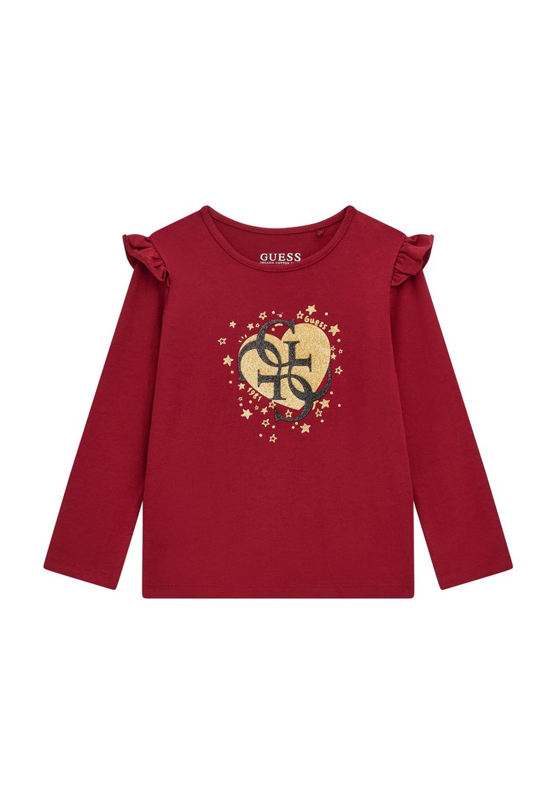 T-shirt a maniche lunghe rossa in cotone con dettagli a volant sulle maniche, un logo a forma di cuore dorato con stelle e il nome del marchio "GUESS" stampato all'interno.