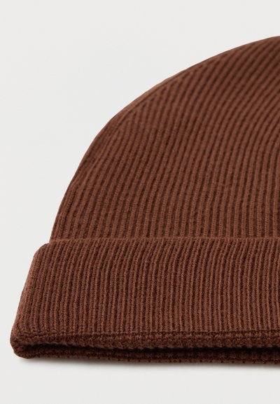 Gorro de punto marrón con textura acanalada, que presenta un dobladillo. El material parece suave y cálido, resaltando un diseño casual y ajustado.