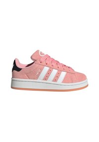 Pink suede low-top sneaker with white three-stripe design, rubber sole, and orange accents on the bottom. Features round laces and padded tongue.