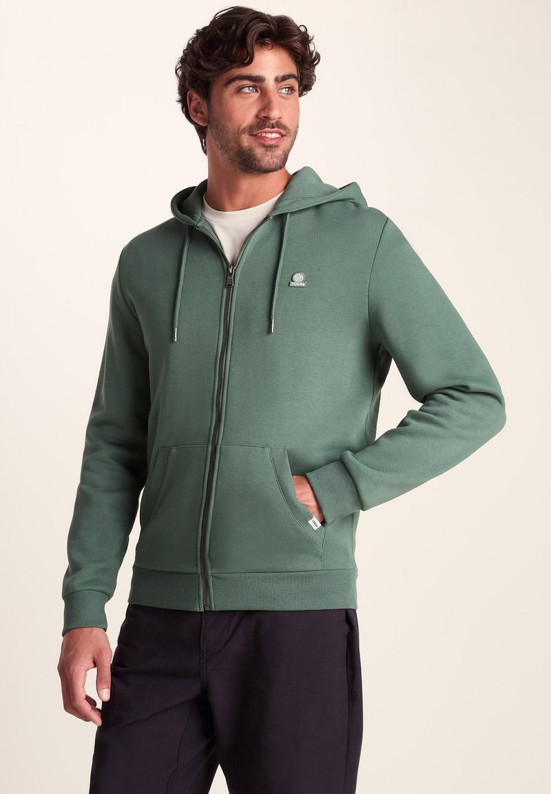 Green zip-up hoodie with a front pocket, drawstring hood, ribbed cuffs and hem, smooth texture, logo on the upper left chest.