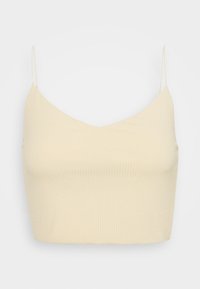 Top corto de color crema con canalé, escote en V y tirantes finos ajustables, con una textura suave y diseño ajustado.