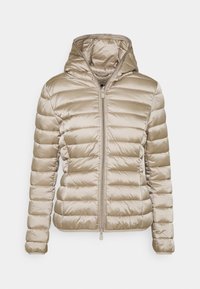 Vaaleanbeige puuvillapuku, jossa on huppu, vaakasuoralla tikatulla suunnittelulla, edessä vetoketju ja sileä, kiiltävä pinta.