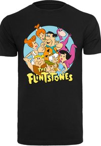 Melns T-krekls ar krāsainu grafiku, kurā attēloti multfilmu varoņi no "Flinstouniem" apļveida dizainā, ar izteiksmīgu dzeltenu tekstu apakšā.