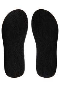 Semelles noires avec une surface texturée présentant un motif géométrique, arrondies aux orteils et aux talons, conçues pour le confort et le soutien.