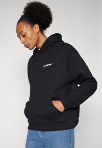 Black hoodie with a front pocket, featuring a white logo on the chest. Made of soft cotton with a relaxed fit and ribbed cuffs.
