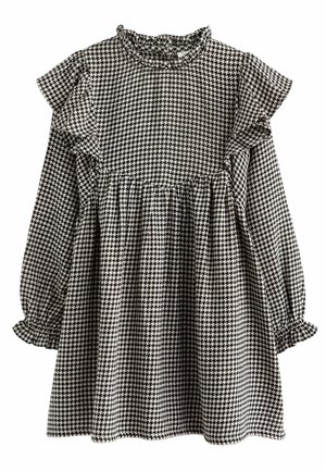 Mustavalkoinen koiranhampaan kuvioinen mekko, jossa pitkät hihat, olkapäillä ja kalvosimissa röyhelökoristeet sekä kerätty vyötäröosa.
