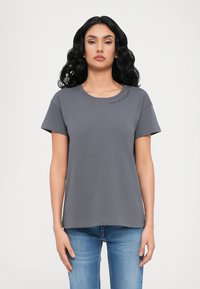 Grijze t-shirt met korte mouwen en een ronde hals, met subtiele tekstdetails op de schouder. Gemaakt van zachte stof met een ontspannen pasvorm.