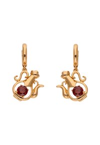Pendientes en tono dorado con forma de teteras, con una piedra roja en el centro y detalles intrincados en el diseño.