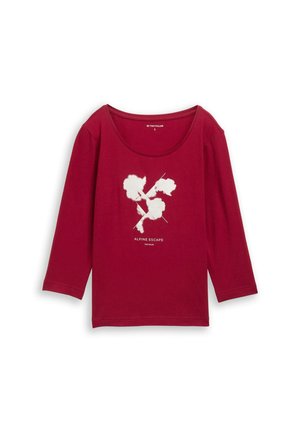 Červené tričko s dlhým rukávom z mäkkého materiálu so zaobleným výstrihom. V strede je biele grafické znázornenie "Alpine Escape".