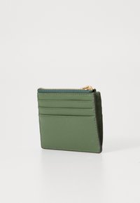 Green leather cardholder with a textured finish, featuring multiple card slots and a zippered compartment at the top. Gold zipper accent.