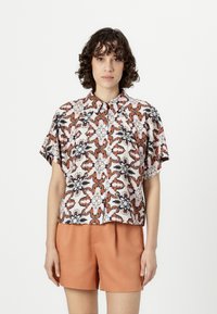 Short-sleeve button-up shirt with a floral pattern in shades of brown, cream, and navy; lightweight fabric; relaxed fit; curved hem.