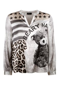 Long-sleeve top featuring a gray and white graphic design with teddy bear, leopard print, and stars. V-neckline and elastic cuffs.