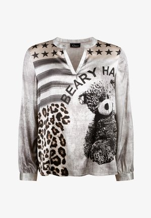 Long-sleeve top featuring a gray and white graphic design with teddy bear, leopard print, and stars. V-neckline and elastic cuffs.