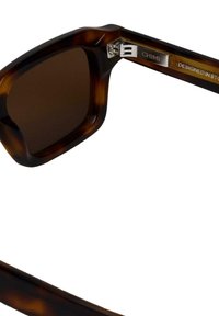 Lunettes de soleil rectangulaires en écaille de tortue avec des verres marron. Monture en acétate, accents en métal argenté et logo à l'intérieur de la branche.