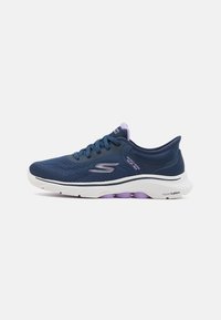Navy blue athletic shoes with mesh upper, textured detailing, white midsole, and purple outsole accents. Features laces and branding.