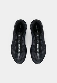 Pair of black and gray Salomon running shoes with quick lace system, viewed from above on a white background.