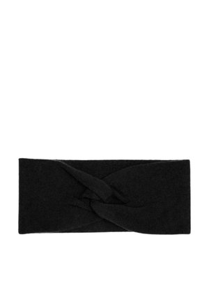 Un bandeau en tissu noir avec un design torsadé, une texture douce et une forme large, porté par une personne aux cheveux blonds dans un pull blanc.