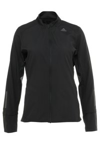 Veste de sport noire avec col montant, fermeture éclair complète, manches longues et accents réfléchissants sur les avant-bras, fabriquée dans un tissu lisse et léger.